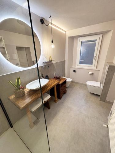a bathroom with a sink and a mirror at Torre Antica Montese appartamento 1 in Montese