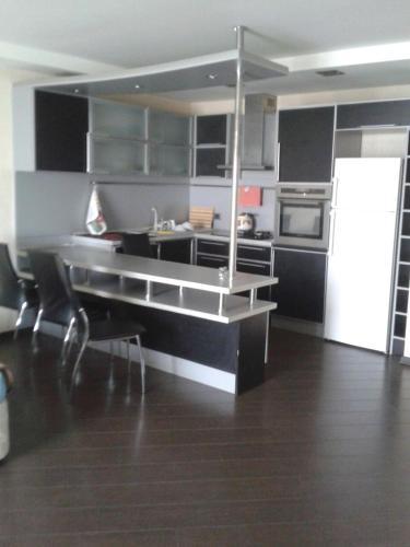 a kitchen with black and white cabinets and appliances at Apartment on Nariman Narimanov in Baku