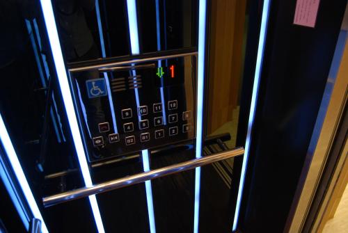 a black microwave oven with its door open at Century Hotel Taoyuan in Taoyuan