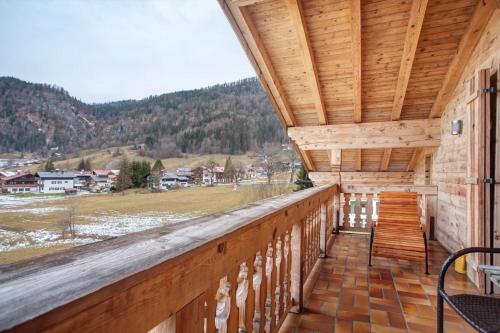 a balcony of a log cabin with a view at Gästehaus Panorama - Appartement 7 in Reit im Winkl