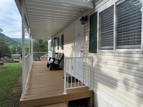 a front porch of a house with a deck at Charming 2 Bedroom Retreat in Pigeon Forge