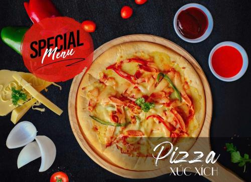 a pizza sitting on top of a table at Green Dragon Boutique Hotel in Cẩm Phả