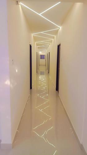 an empty hallway with white walls and white floors and ceilings at SSK Rooms in Gūduvāncheri