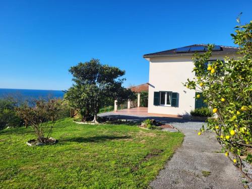 a house with a view of a yard at P r a t o e O n d e in Cogoleto