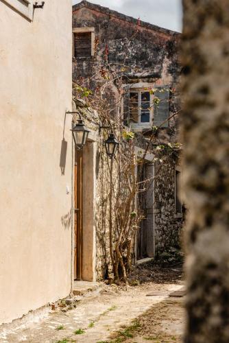 an old building with a door and a lamp next to it at Krasospito 1850 - a Corfiot Wine House Reborn in Lefkimmi