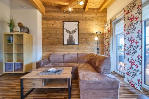 a living room with a couch and a table at Apartment Wallner in Fieberbrunn
