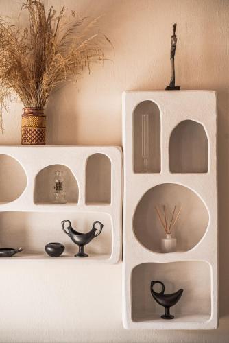 a white shelf with a statue on top of it at Fasolaki Skopelos - Eco Residences in Skopelos Town