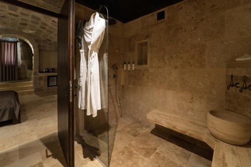 a bathroom with a shower and a toilet at Luvi Cave Hotel in Goreme