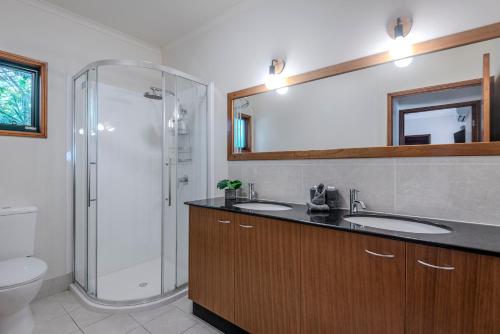 a bathroom with two sinks and a shower at Casuarina Cove 1 on Hamilton Island by HamoRent in Hamilton Island