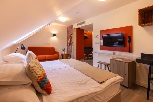 a bedroom with a large bed and a television at Vadkert Major in Sárvár
