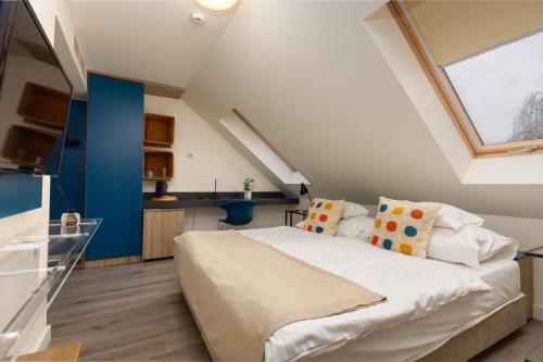 a bedroom with a large bed and a window at Vadkert Major in Sárvár