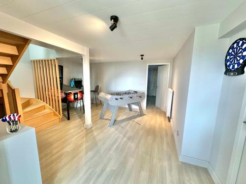 a living room with a table in the middle of a room at Vue Mer avec Terrasse sur la plage de Berck et 2 Places de Parking in Berck-sur-Mer