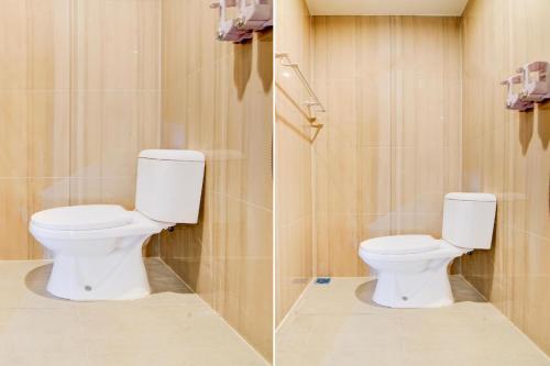 a bathroom with a white toilet in a room at Capital O Pusat Kota Pekanbaru Near Mall Living World Formerly Radja Homestay in Pekanbaru