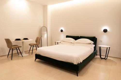 a bedroom with a bed and a table and chairs at Dimora Zonno in Bari