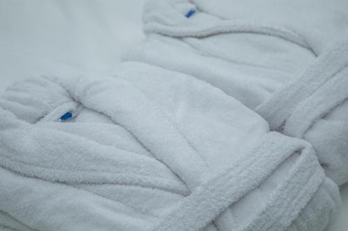 a close up of a white blanket on a bed at El Palacio by Standby in Soria