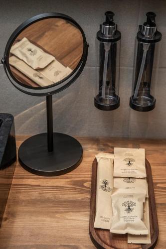 a table with a mirror and some towels on a tray at El Palacio by Standby in Soria
