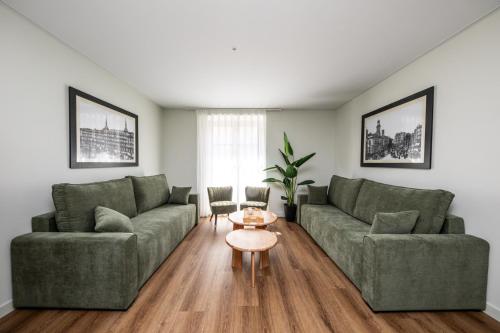 a living room with two couches and a table at El Palacio by Standby in Soria