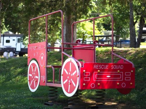 a red play system in a park at Cozy 1BR Mountain Retreat in Pigeon Forge