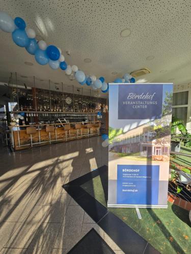 a building with a blue and white sign on the ceiling at Hotel Bördehof, direkt an der A2 & A14, Restaurant, Tagung, individuell in Barleben