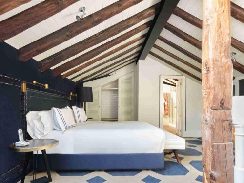 a bedroom with a large white bed and a table at Only YOU Boutique Hotel Madrid in Madrid