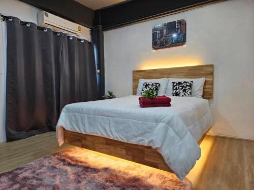 a bedroom with a large bed with a camera on the wall at Irich Bang Hua Suae 6kms from BTS Pu-Chao in Ban Bang Chak