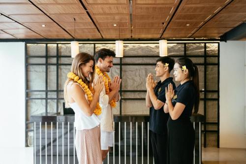 a group of people standing in a room applauding at Nadi Hotel Legian in Legian