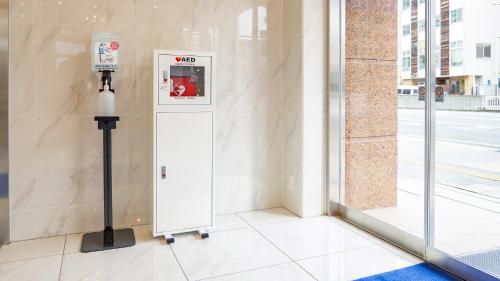 a ticket machine sitting on the side of a building at Toyoko Inn Takamatsu Ekimae in Takamatsu