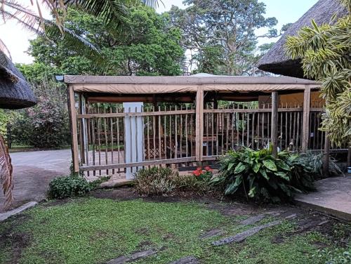 a wooden gazebo with a fence in a yard at Pennington Beach Cottage Holiday accommodation in Pennington