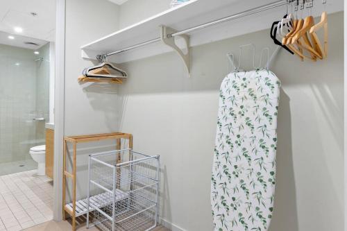 a bathroom with a towel hanging on a wall at Harbourfront Urban Oasis in Melbourne