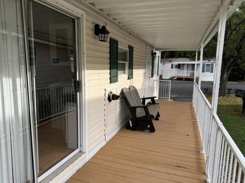 a porch with a rocking chair on a house at Perfect 2BR Mountain Retreat in Pigeon Forge