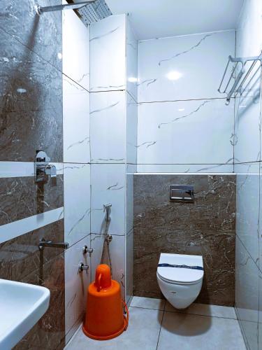 a bathroom with a toilet and a sink at Hotel Jeyam in Kanyakumari