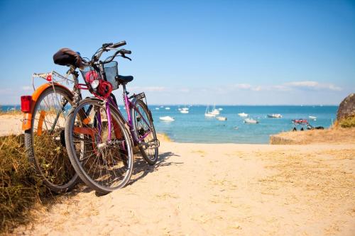 two bikes parked on the beach near the ocean at Camping maeva Escapades de la Gères in Surgères