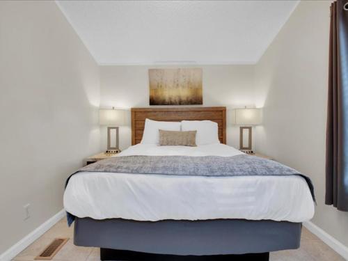 a bedroom with a large bed with two lamps at Lovely 2BR Model Home in the Smokies in Pigeon Forge