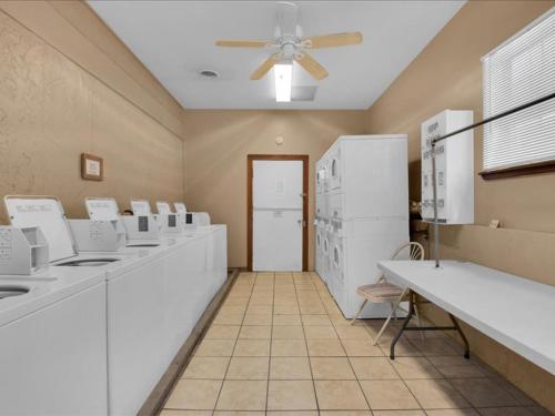 a kitchen with white appliances and a ceiling fan at Lovely 2BR Model Home in the Smokies in Pigeon Forge