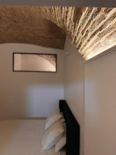 a room with pillows on a bed with a ceiling at SottoAlCampanile in Campomarino