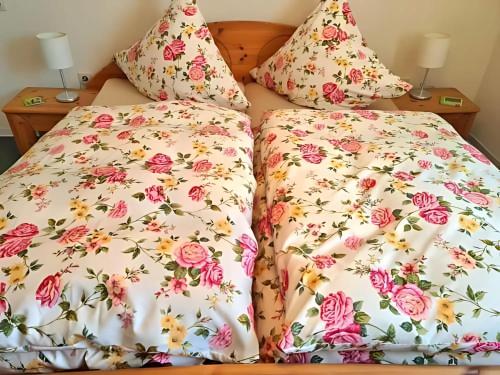 a bed with two pillows on top of each other at Apartment Pusteblume in Sankt Martin