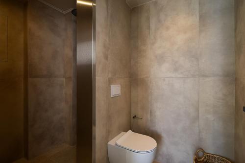a bathroom with a white toilet in a room at Villa Aya - Coastal Villa, Minimalist Elegance by etouri in Stavromenos