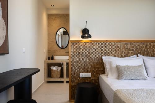 a bedroom with a bed and a mirror at Villa Aya - Coastal Villa, Minimalist Elegance by etouri in Stavromenos