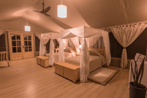a bedroom with a bed with a canopy at MAISHA SWEETWATERS CAMP in Ol Pejeta Conservancy