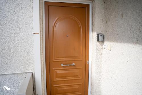 a brown door in the side of a building at 'Nefeli' House With Amazing View Βy The Sea in Nea Makri