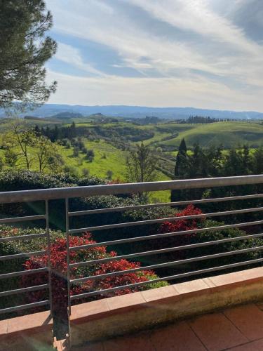 a bench with flowers on top of a hill at Casale del Vacanziere in Certaldo