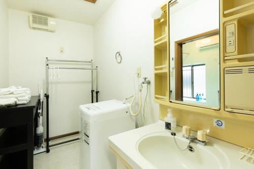 a bathroom with a sink and a washing machine at 緑翠-Ryokusui- in Fukuoka