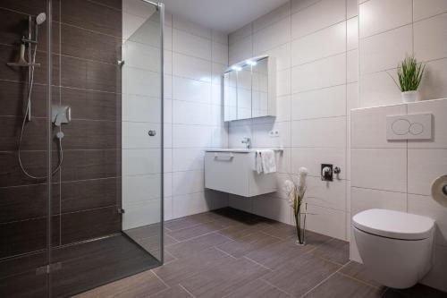 a bathroom with a shower and a toilet and a sink at City Appartement - Standard in Schwaz