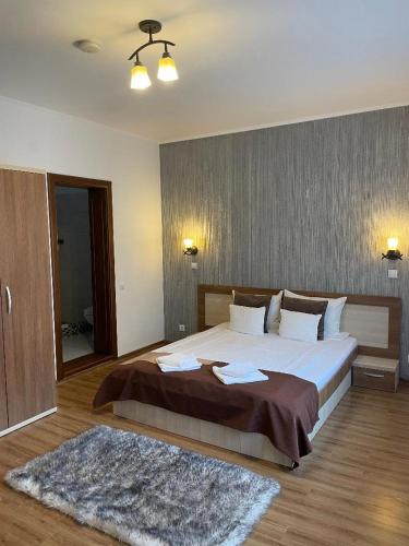 a bedroom with a large bed and a mirror at Villa Prestige in Sovata