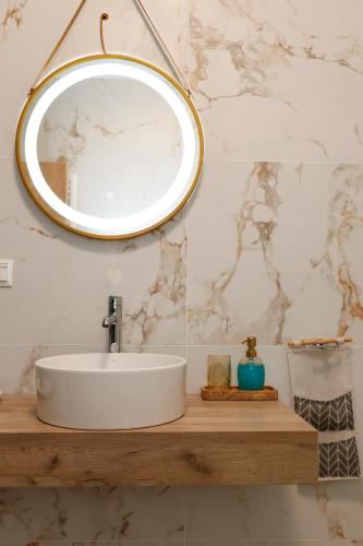 a bathroom with a white sink and a mirror at Bebis House in Prosílion