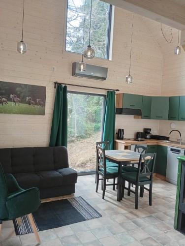 a living room with a couch and a table at Chatka na Przełęczy in Sokolec
