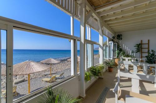 a balcony with a view of the beach and the ocean at VistaMare2 Double room-sea view in Koutsourás