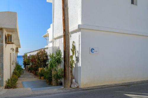 a white building with a pole next to a street at VistaMare2 Double room-sea view in Koutsourás