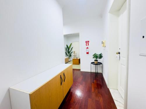 a hallway with white walls and wood flooring at Casa Campos - Refresh - 2-bedroom apartment in Ovar