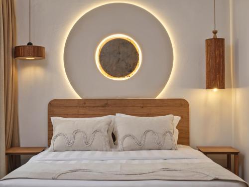 a bedroom with a bed with a large orb above it at Iria Blue Mykonos in Platis Yialos Mykonos